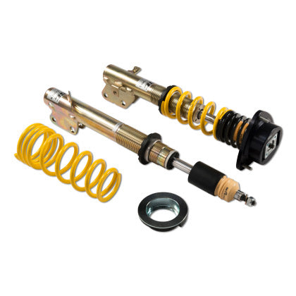 One assembled vehicle suspension coilover, one sleeved coilover strut and one yellow coilover spring