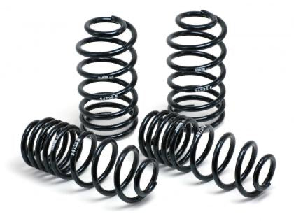 4 black vehicle suspension lowering springs.