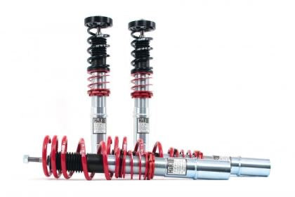 4 vehicle suspension coilovers with black and red springs