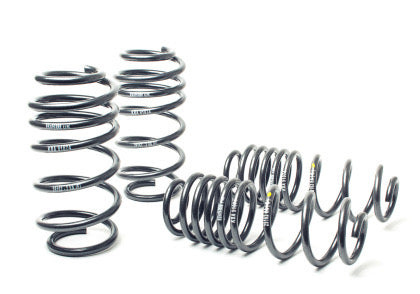 4 black vehicle suspension lowering springs.