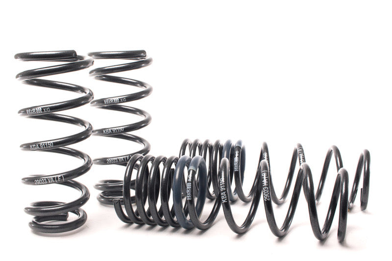 4 black vehicle suspension lowering springs.