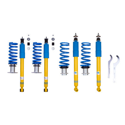 4 Bilstein yellow bodied vehicle suspension coilovers with blue strut sleeve and 4 blue springs with end fittings, 2 coilover adjustment tools and fixtures.