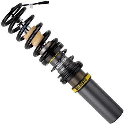 Gray bodied vehicle suspension coilover strut with fitted black spring and yellow accents.