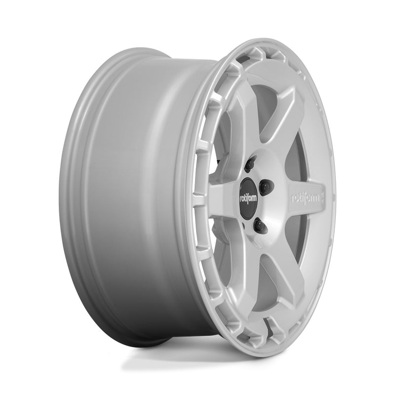 Side view of a Rotiform Ken Block Signature Wheel KB1 is a cast aluminum 6 Spoke automotive wheel in a gloss silver finish with a Rotiform and Ken Block Logo embossed in one spoke along with a Rotiform silver logo center cap.