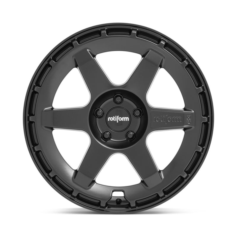 Front face view of a Rotiform Ken Block Signature Wheel KB1 is a cast aluminum 6 Spoke automotive wheel in a matte black finish with a Rotiform and Ken Block Logo embossed in one spoke along with a Rotiform silver logo center cap.