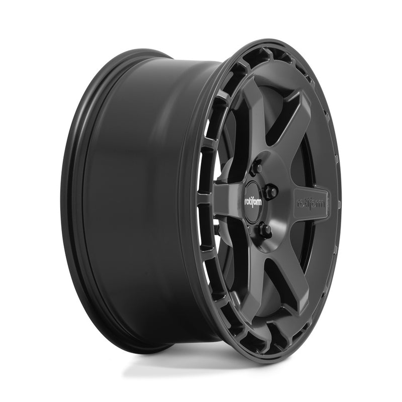 Side view of a Rotiform Ken Block Signature Wheel KB1 is a cast aluminum 6 Spoke automotive wheel in a matte black finish with a Rotiform and Ken Block Logo embossed in one spoke along with a Rotiform silver logo center cap.