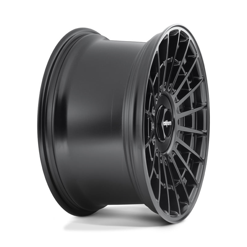 Side view of a Rotiform LAS-R monoblock cast aluminum multi spoke automotive wheel in matte black with a black center cap having a silver Rotiform logo.