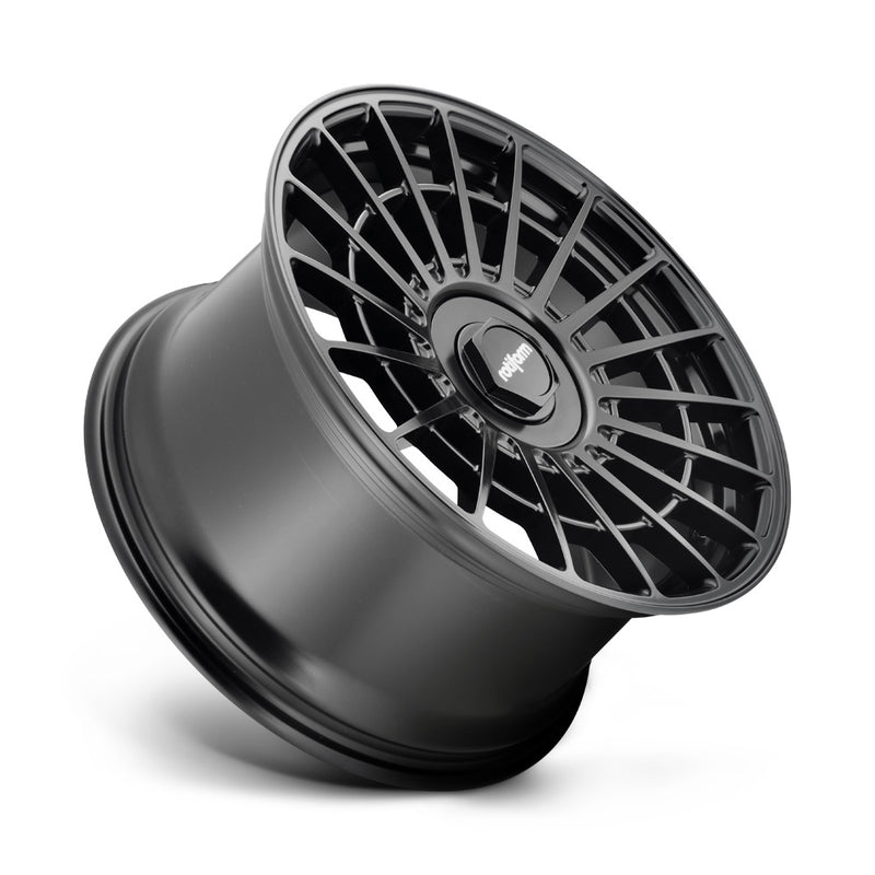 Tilted side view of a Rotiform LAS-R monoblock cast aluminum multi spoke automotive wheel in matte black with a black center cap having a silver Rotiform logo.