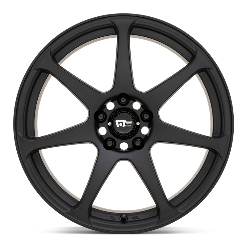 Front face view of a Motegi Racing Battle cast aluminum 7 spoke automotive wheel in a matte black finish with a black center cap displaying a silver Motegi logo.