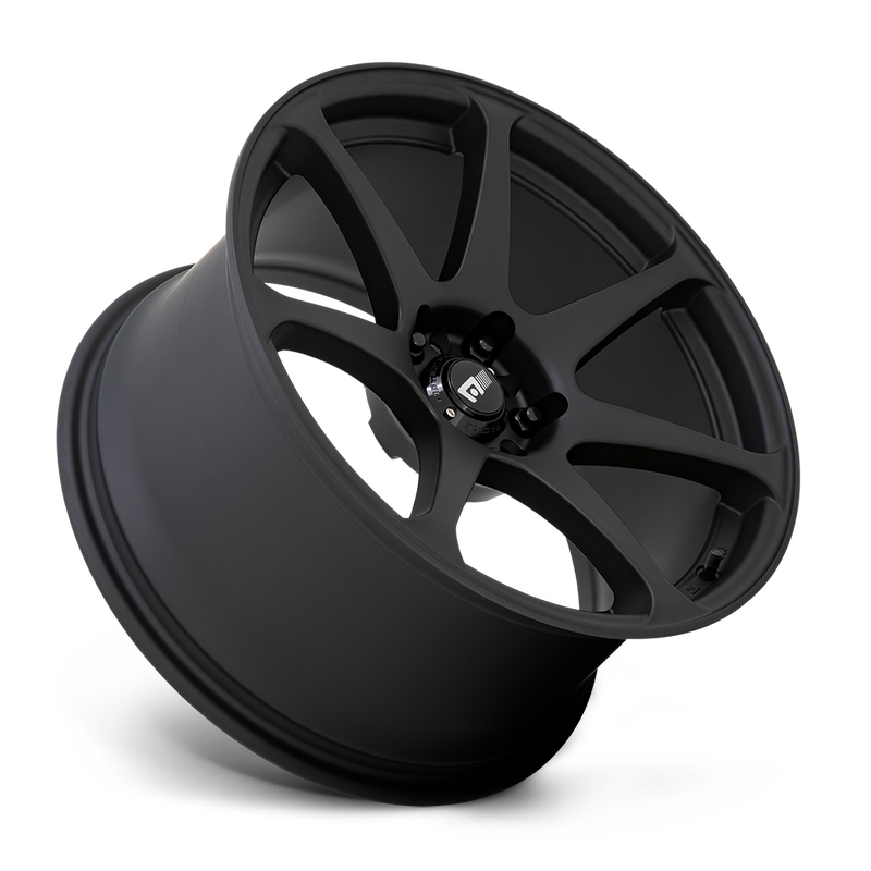 Tilted side view of a Motegi Racing Battle cast aluminum 7 spoke automotive wheel in a matte black finish with a black center cap displaying a silver Motegi logo.