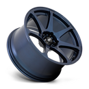 Tilted side view of a Motegi Racing Battle cast aluminum 7 spoke automotive wheel in a midnight blue finish with a black center cap displaying a silver Motegi logo.