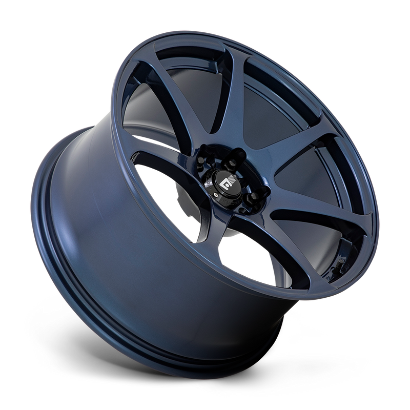 Tilted side view of a Motegi Racing Battle cast aluminum 7 spoke automotive wheel in a midnight blue finish with a black center cap displaying a silver Motegi logo.