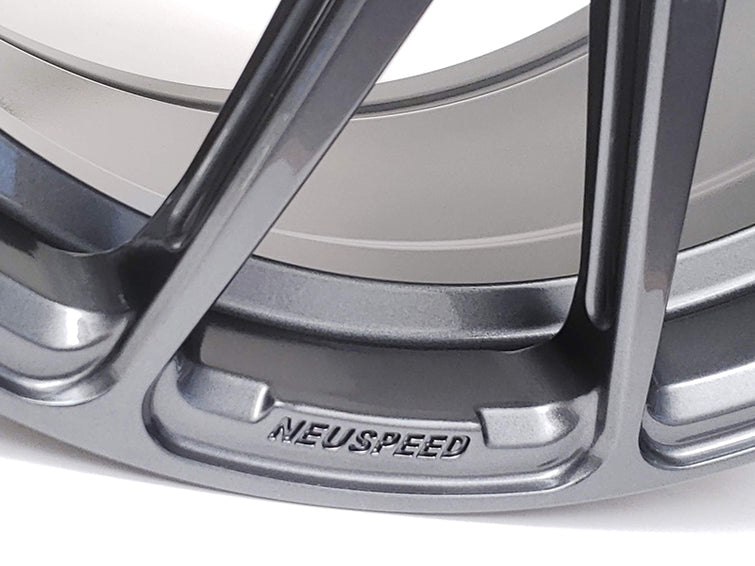 Close of the lip of an automotive alloy wheel  showing the word etched word Neuspeed.