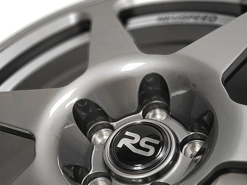 Close up view of the lug holes and the RS logo center cap of a Neuspeed automotive alloy wheel.