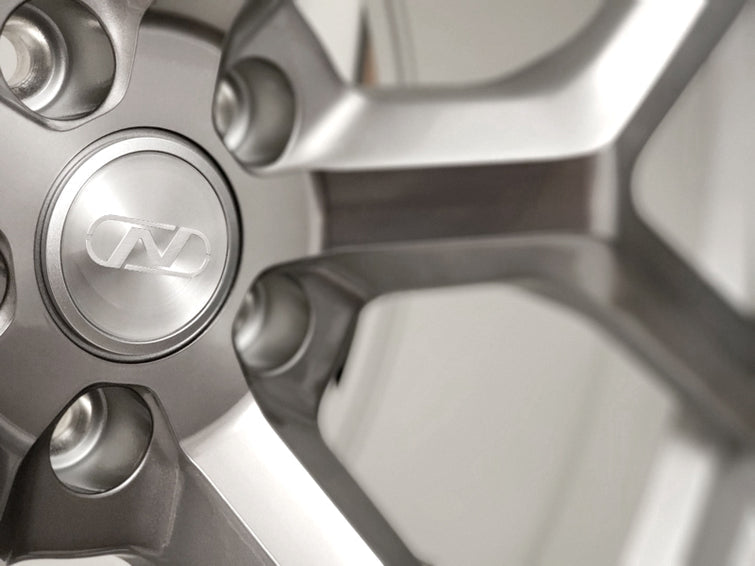 Close up of a Neuspeed lightweight 10 spoke automotive alloy wheel in a silver platinum finish.