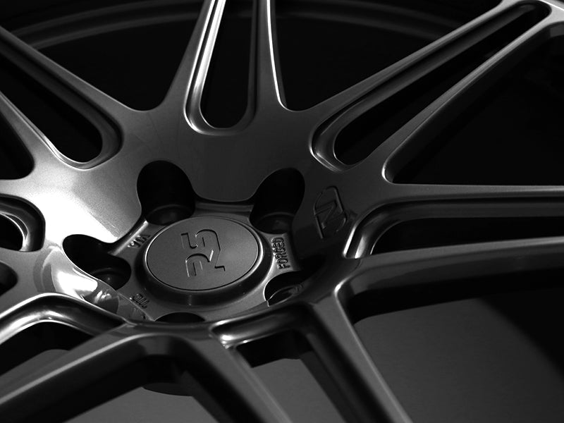 Close up of Neuspeed RS center cap and lugs on an automotive allow wheel in a gloss gun metallic finish.