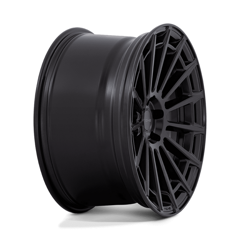 Side view of a Niche Amalfi monoblock cast aluminum 15 spoke automotive wheel in a matte black finish with an embossed Niche logo on the outer lip and a Niche logo center cap.