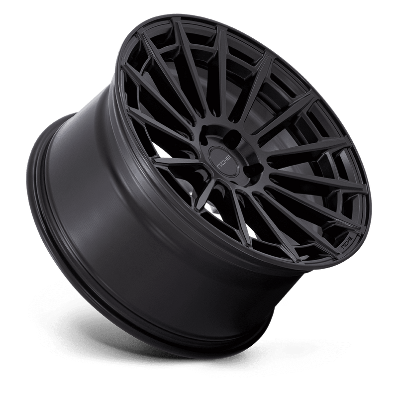 Tilted side view of a Niche Amalfi monoblock cast aluminum 15 spoke automotive wheel in a matte black finish with an embossed Niche logo on the outer lip and a Niche logo center cap.