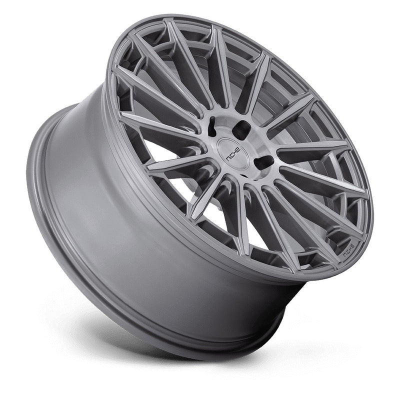 Tilted side view of a Niche Amalfi monoblock cast aluminum 15 spoke automotive wheel in a platinum finish with an embossed Niche logo on the outer lip and a Niche logo center cap.