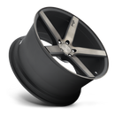 Tilted side view of a Niche Milan monoblock cast aluminum 5 spoke automotive wheel in a matte black machined double dark tint finish with an embossed Niche logo in one spoke and a Niche silver logo center cap.