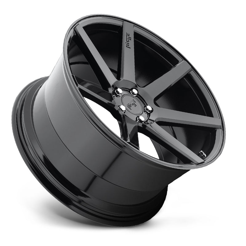 Tilted side view of a Niche Verona monoblock cast aluminum 7 spoke concave profile automotive wheel in a gloss black finish with an embossed Niche Logo on one spoke and a Niche black logo center cap.