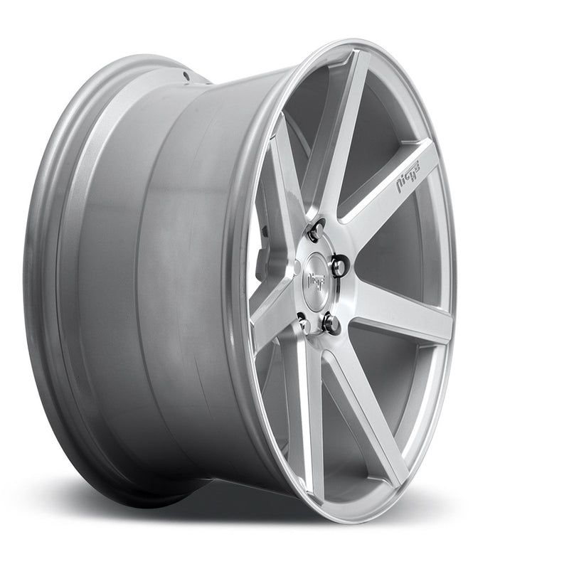 Side view of a Niche Verona monoblock cast aluminum 7 spoke concave profile automotive wheel in a gloss silver machined finish with an embossed Niche Logo on one spoke and a Niche silver logo center cap.