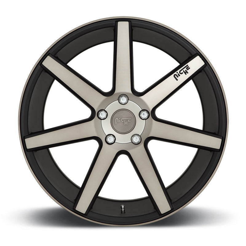 Front face view of a Niche Verona monoblock cast aluminum 7 spoke concave profile automotive wheel in a matte black machined finish with an embossed Niche Logo on one spoke and a Niche logo center cap.