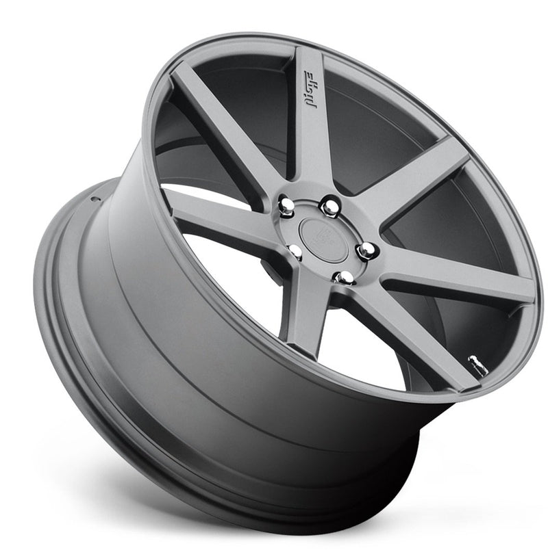 Tilted side view of a Niche Verona monoblock cast aluminum 7 spoke concave profile automotive wheel in a matte gun metal gray finish with an embossed Niche Logo on one spoke and a Niche logo center cap.