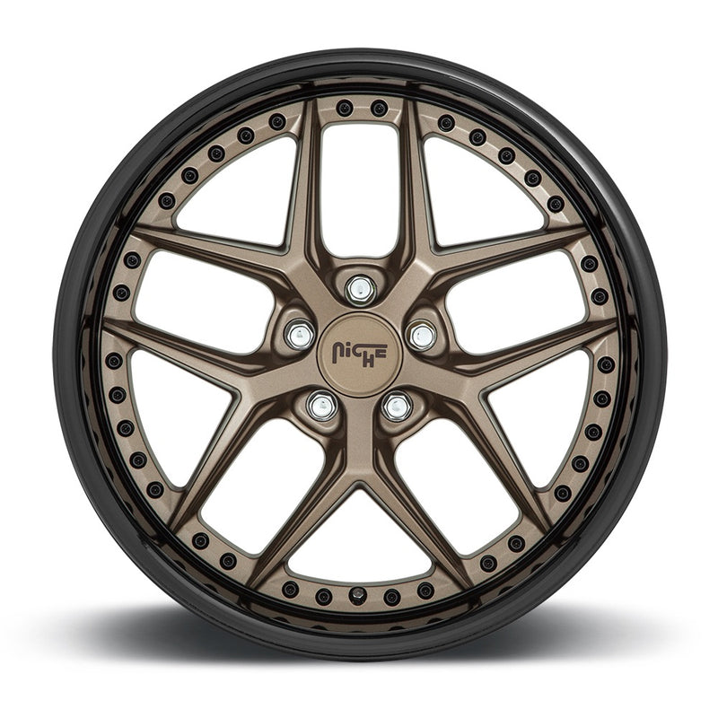 Front face view of a Niche Vice monoblock cast aluminum 5 V shape spoke automotive wheel in a matte bronze with black bead ring finish with a bolt design on the inner lip and a Niche logo center cap