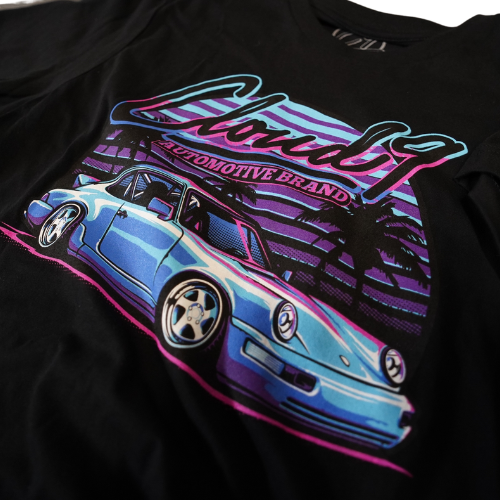 Close up view of Cloud 9 Automotive Brand blue Porsche design on front of black t-shirt