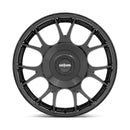 Front face view of a Rotiform TUF-R monoblock cast aluminum 7 spoke design automotive wheel in gloss black finish with a black center cap with a silver Rotiform logo.
