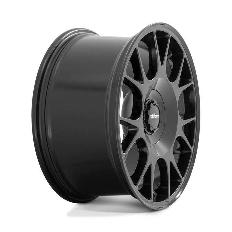 Side view of a Rotiform TUF-R monoblock cast aluminum 7 spoke design automotive wheel in gloss black finish with a black center cap with a silver Rotiform logo.