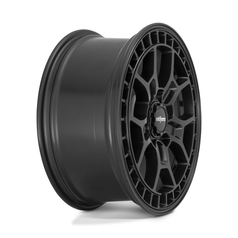 Side view of a Rotiform ZMO-M monoblock cast aluminum 5 Y shape spoke automotive wheel in a matte black finish with a square hole pattern to the outer edge and a black center cap with a silver Rotiform logo.