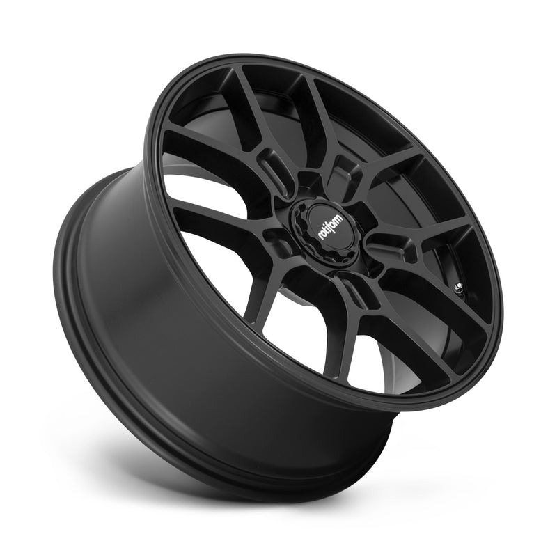 Tilted side view of a Rotiform ZMO monoblock cast aluminum 5 Y shape spoke automotive wheel in a matte black finish with a black center cap having a silver Rotiform logo.